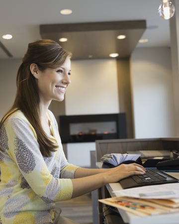 Professional woman typing at desk.